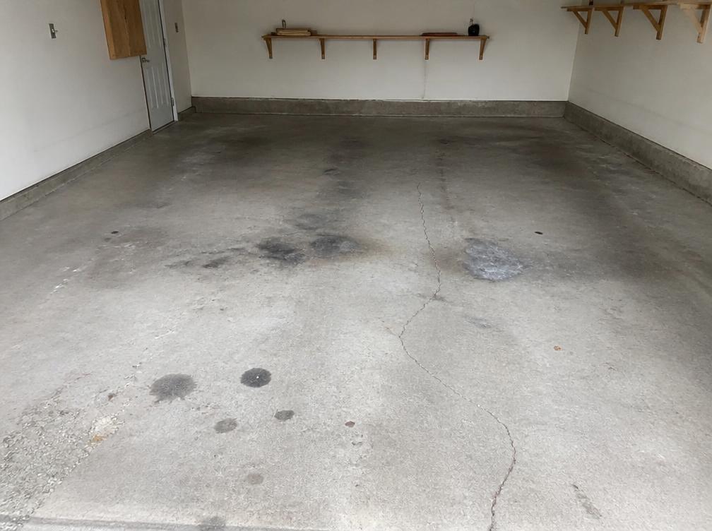 Before: stained cracked bare concrete garage floor in Wilmington DE