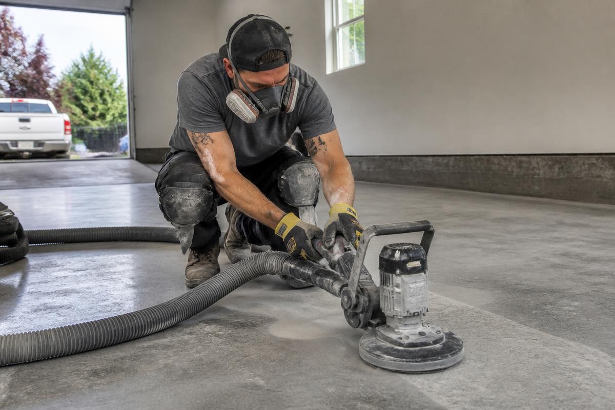 Epoxy flooring crew diamond grinding a concrete garage floor in New Castle County DE